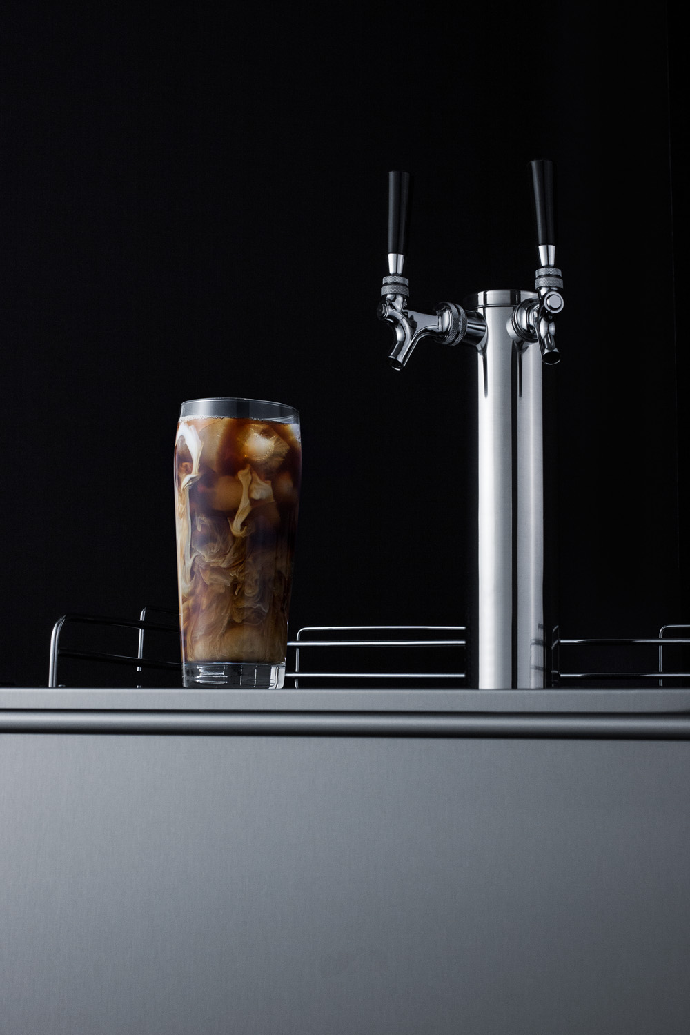 Built-in undercounter ADA height commercially listed dual tap cold brew coffee dispenser with panel-ready door and black cabinet